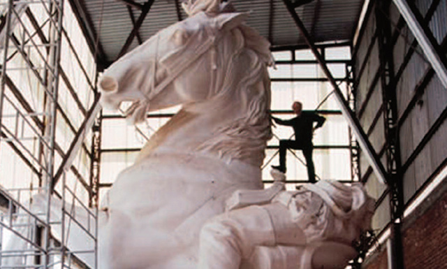 Artist standing on horse statue