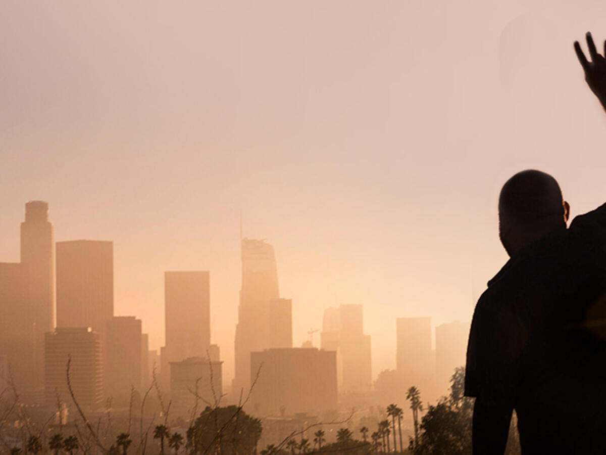 Silhouette of student overlooking LA skyline