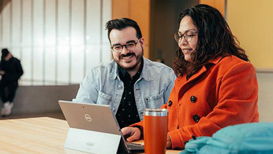 people looking at a laptop